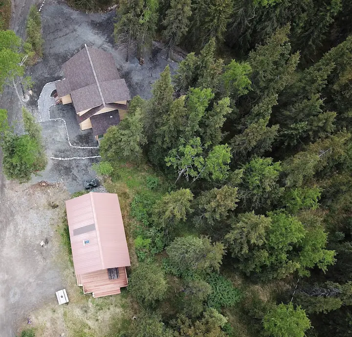 An aerial view of the Paradise Log Cabins. The Upper Paradise Log Cabin in on the bottom of the photo and the new, Lower Paradise Log Cabin is on the top.  Each has a private yard but shared driveway.