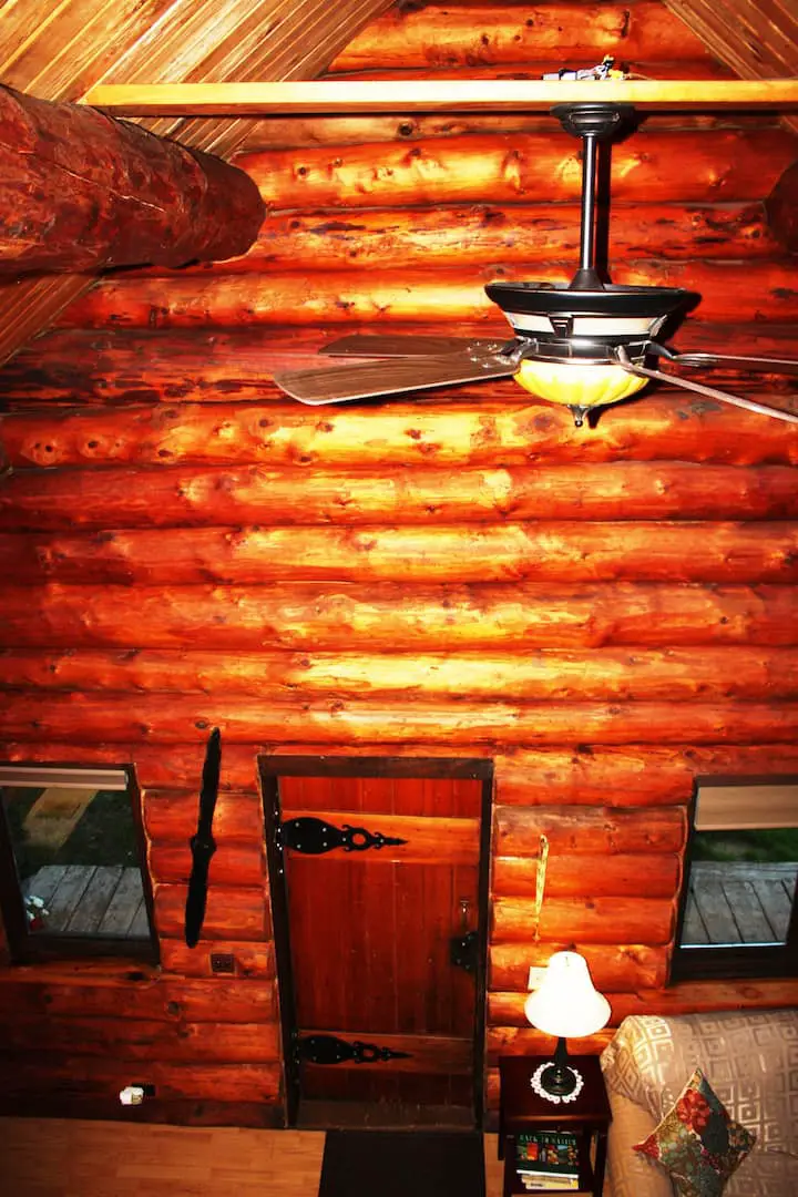 A view of the downstairs of the log cabin from the loft. 